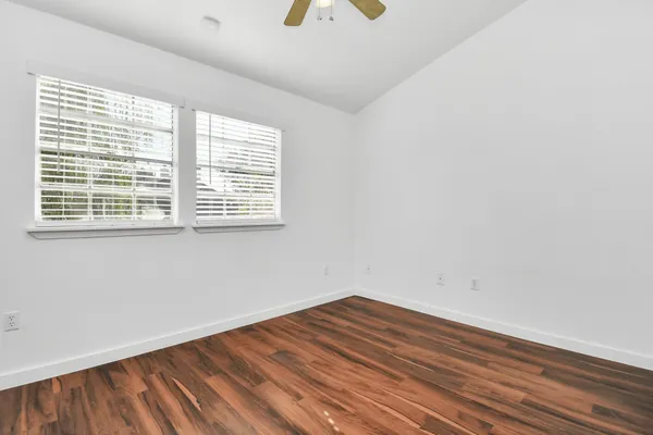 wooden floor in an empty room with a window