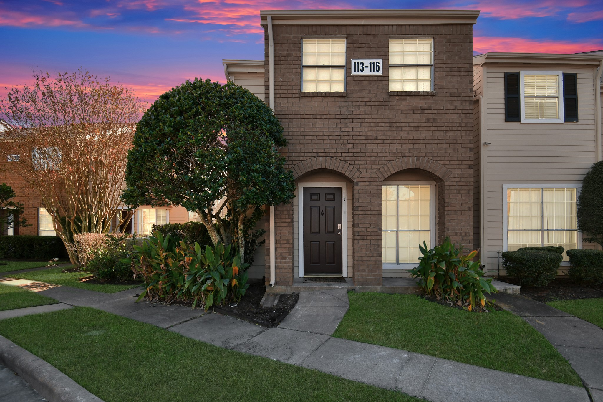 2002 Gentryside Drive, Unit 113 Houston, TX 77077 - Photo 2 of 32 a front view of a house with a garden