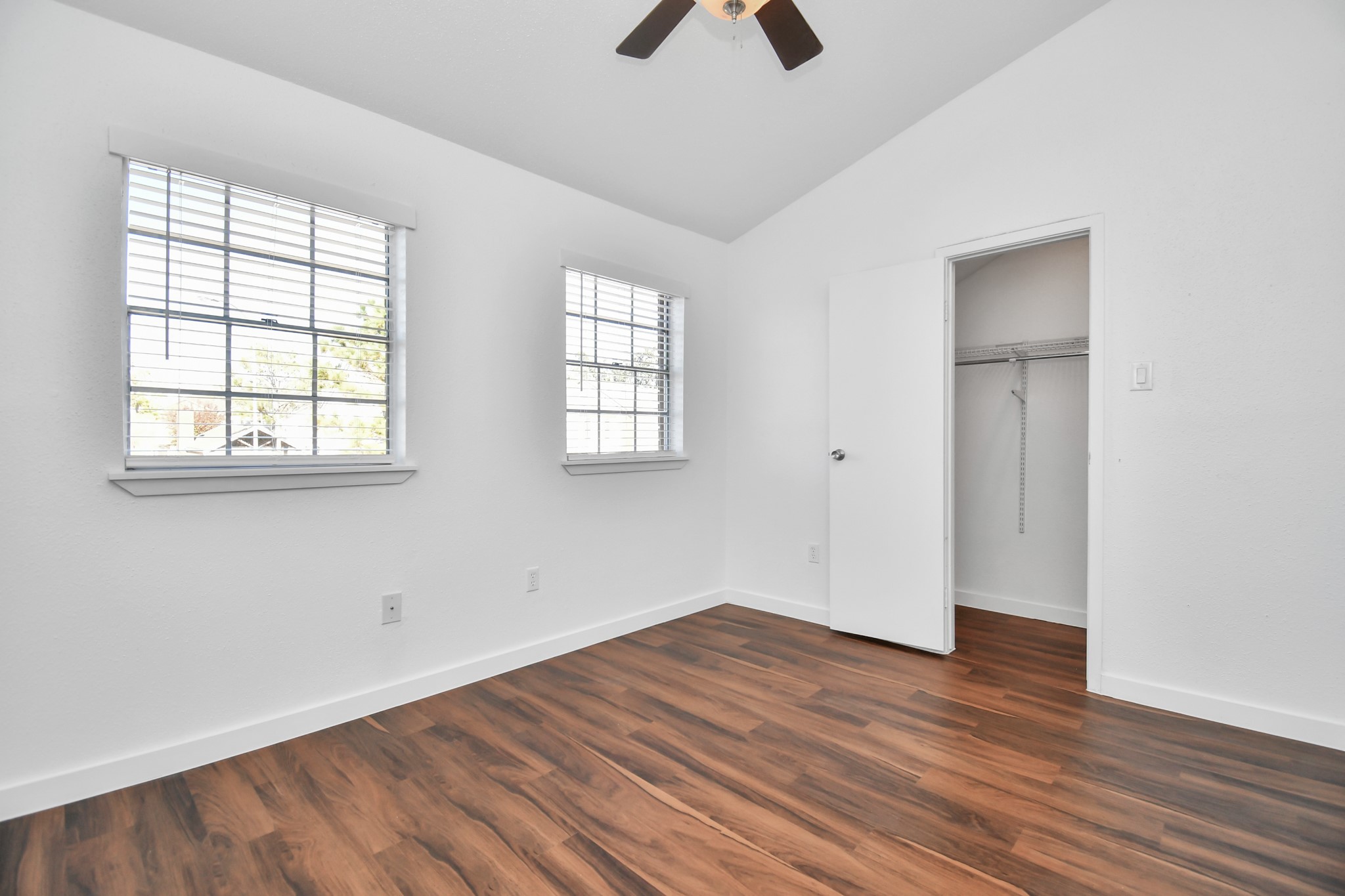 2002 Gentryside Drive, Unit 113 Houston, TX 77077 - Photo 24 of 32 an empty room with wooden floor and windows