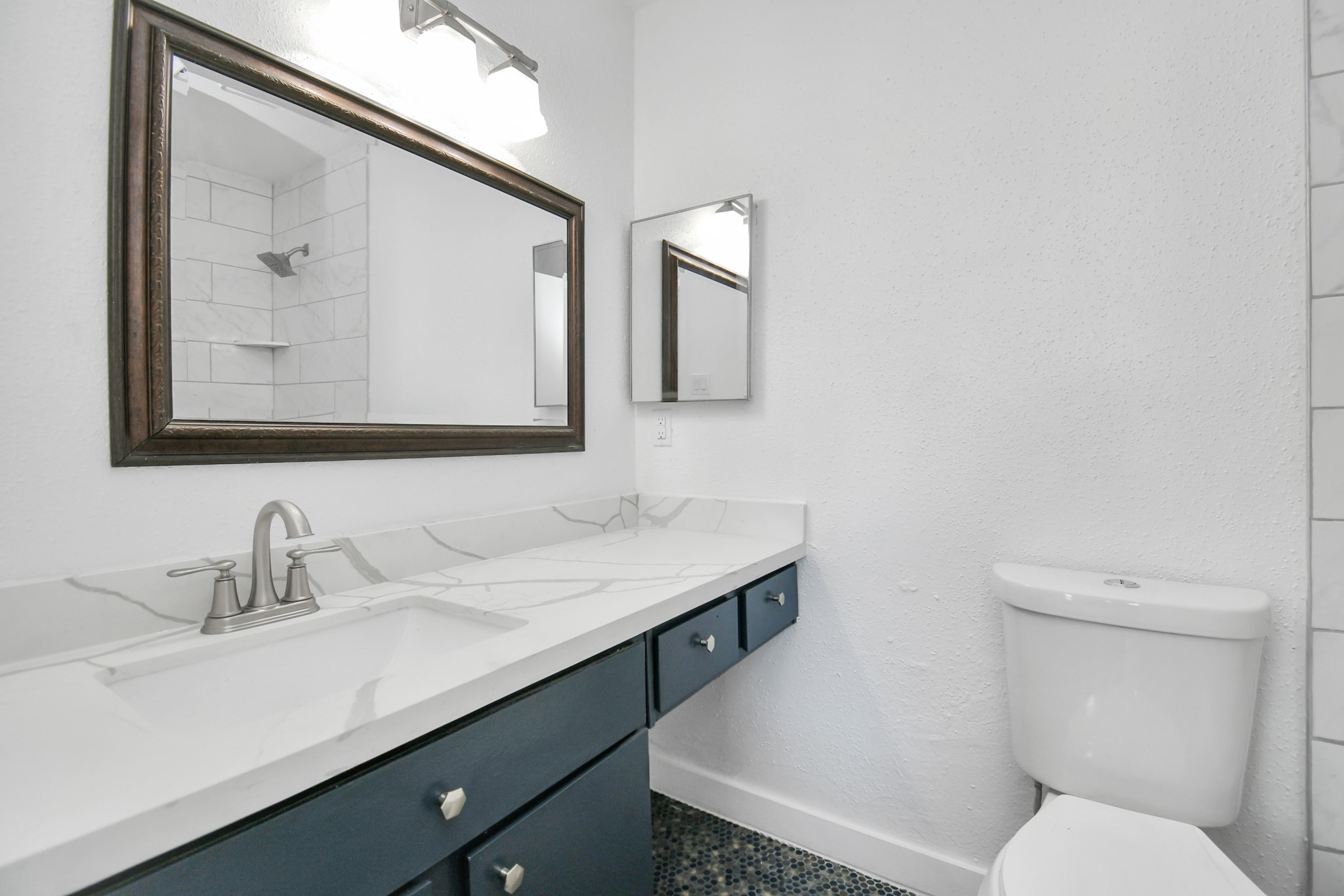 2002 Gentryside Drive, Unit 113 Houston, TX 77077 - Photo 25 of 32 a bathroom with a toilet sink and mirror