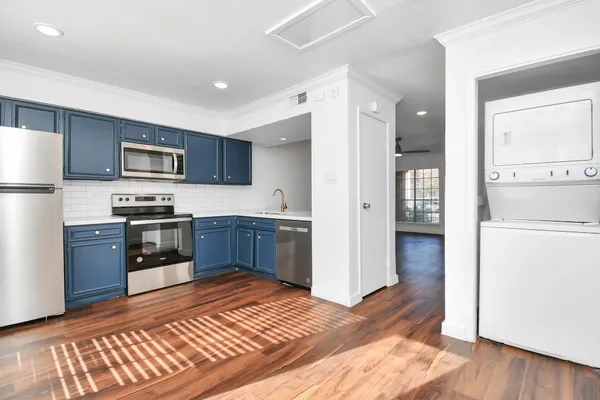 a kitchen with granite countertop stainless steel appliances and wooden cabinets