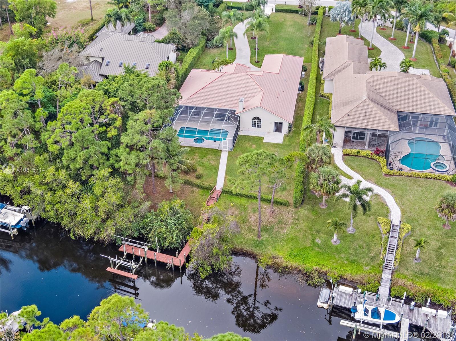 18897 Southeast Loxahatchee River Road Jupiter, FL 33458 - Photo 1 of 48 Welcome Home! Aerial view of home, backyard, pool, and lanai, 34ft dock and boat lift on canal with ocean access!