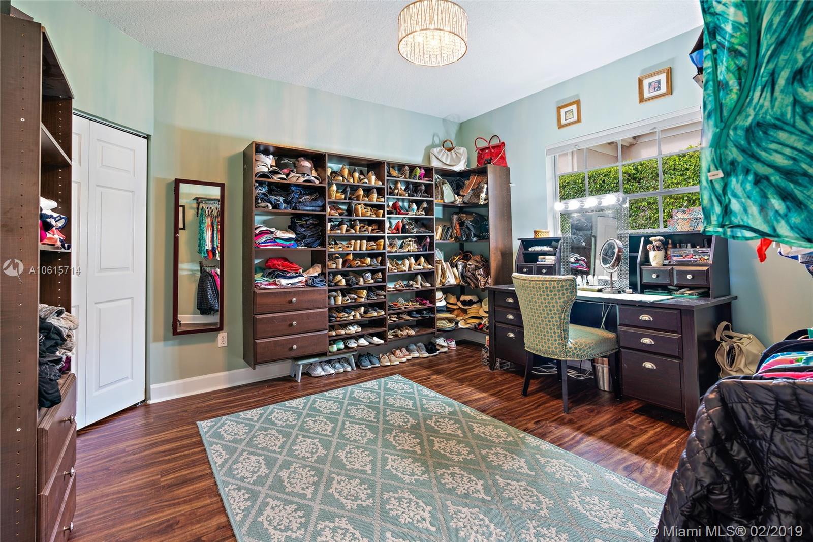 18897 Southeast Loxahatchee River Road Jupiter, FL 33458 - Photo 20 of 48 Second Bedroom 13ft x 12ft with walk in closet. Currently being used as a woman's dream closet. Seller will leave shelving as is or remove shelving to return to a bedroom prior to closing.