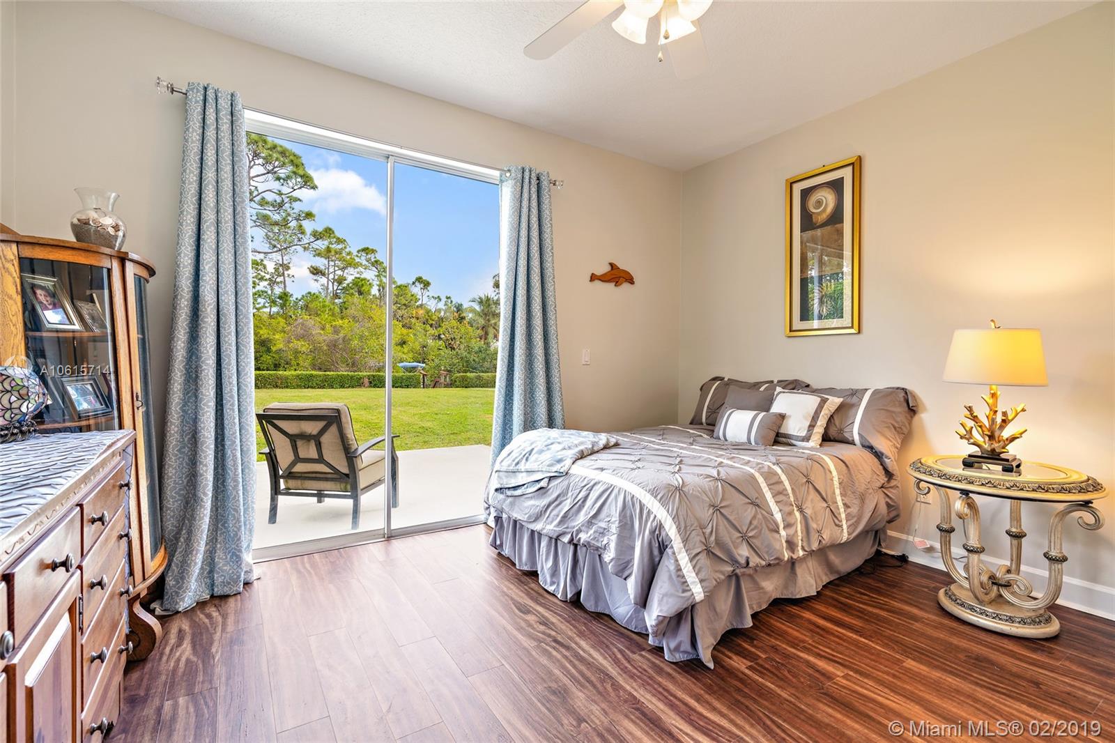 18897 Southeast Loxahatchee River Road Jupiter, FL 33458 - Photo 22 of 48 Fourth Bedroom 13ft x 12.3ft with sliders to patio. Lots of natural light.