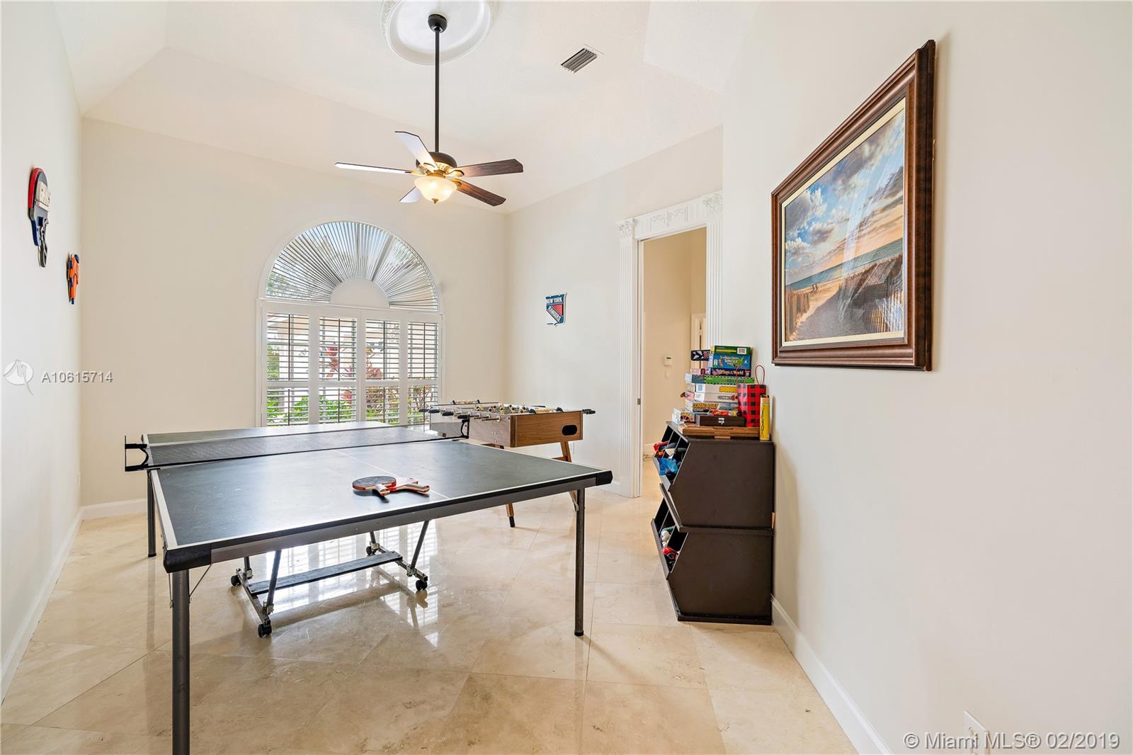18897 Southeast Loxahatchee River Road Jupiter, FL 33458 - Photo 23 of 48 Formal dining room with marble floors currently being used as a game room. Plantation shutters and pocket door.