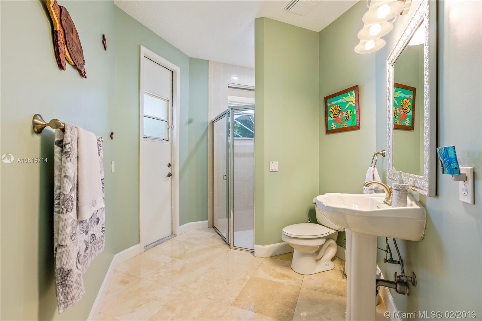 18897 Southeast Loxahatchee River Road Jupiter, FL 33458 - Photo 24 of 48 Cabana bath with access door to lanai and pool area.