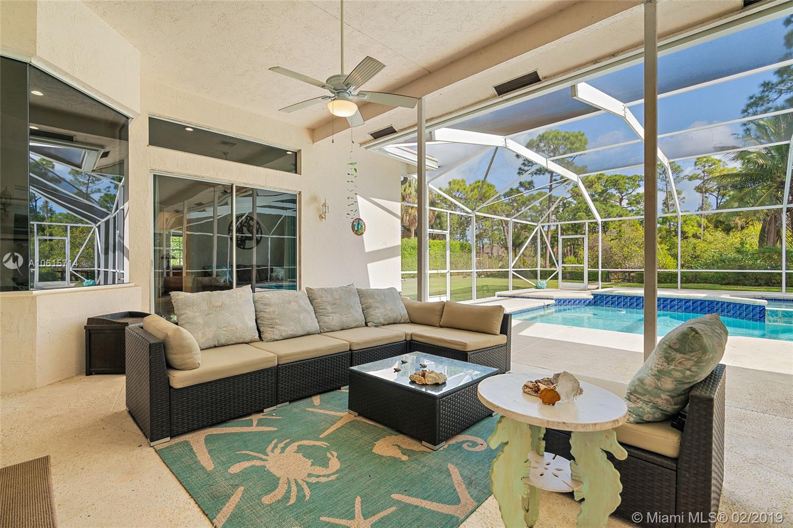 18897 Southeast Loxahatchee River Road Jupiter, FL 33458 - Photo 26 of 48 Outdoor living room in covered lanai 45ft x 33ft and screened in pool area 45ft x 18ft.