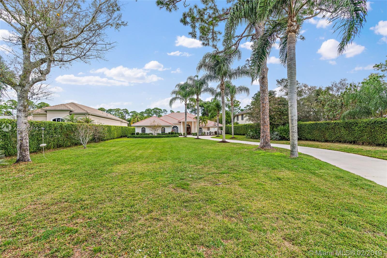18897 Southeast Loxahatchee River Road Jupiter, FL 33458 - Photo 29 of 48 Front exterior view with long driveway.