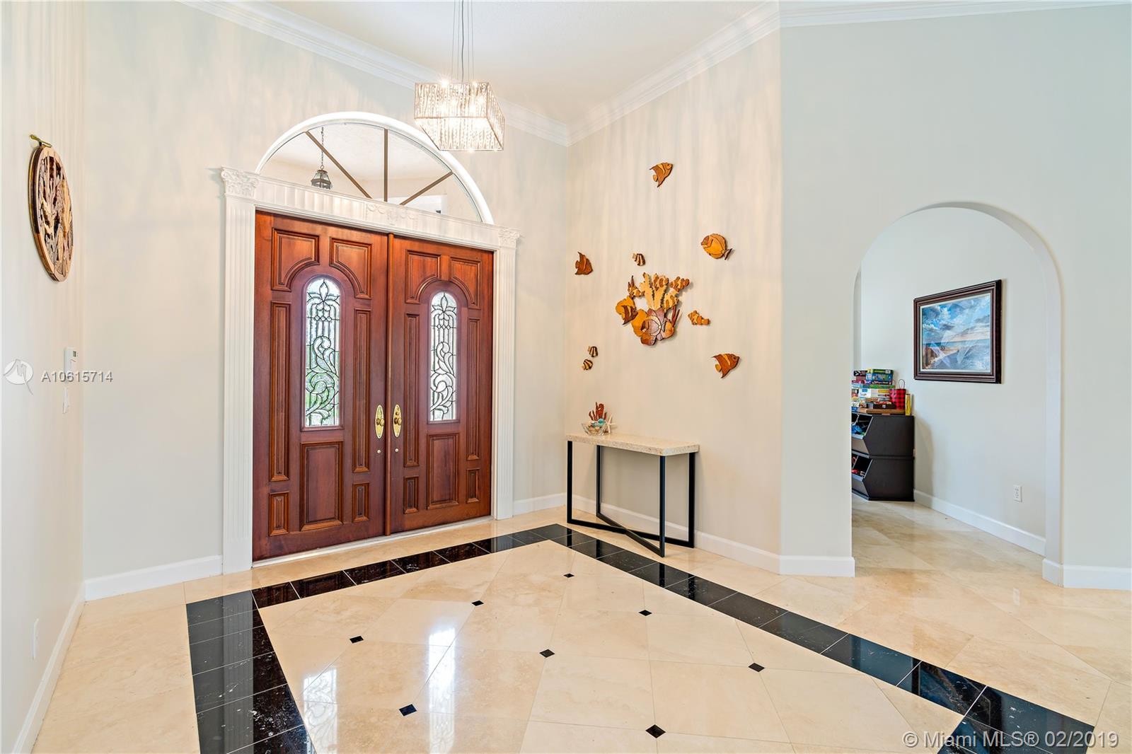 18897 Southeast Loxahatchee River Road Jupiter, FL 33458 - Photo 4 of 48 Front foyer/entry area with marble floors. Archway leads to formal dining room.