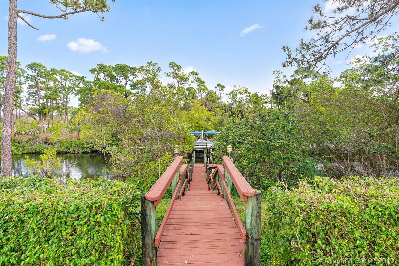 18897 Southeast Loxahatchee River Road Jupiter, FL 33458 - Photo 31 of 48 Walkway/stairs leading to 34ft dock with boat lift.