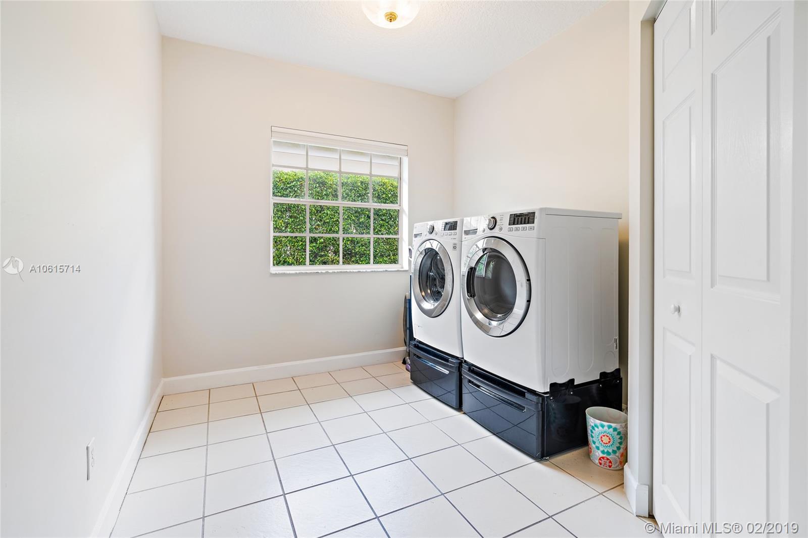 18897 Southeast Loxahatchee River Road Jupiter, FL 33458 - Photo 39 of 48 Laundry/ utility room with loads of storage. Washer and Dryer do not convey.