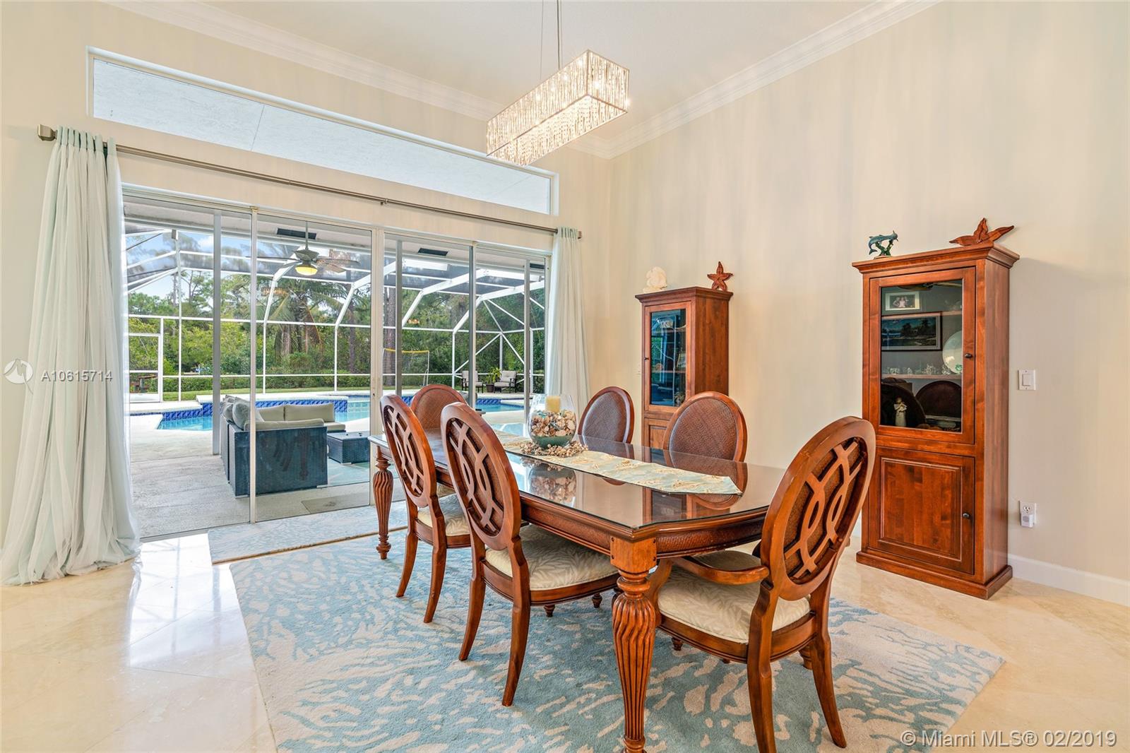 18897 Southeast Loxahatchee River Road Jupiter, FL 33458 - Photo 6 of 48 Dining area with sliding glass doors to covered lanai and pool area.