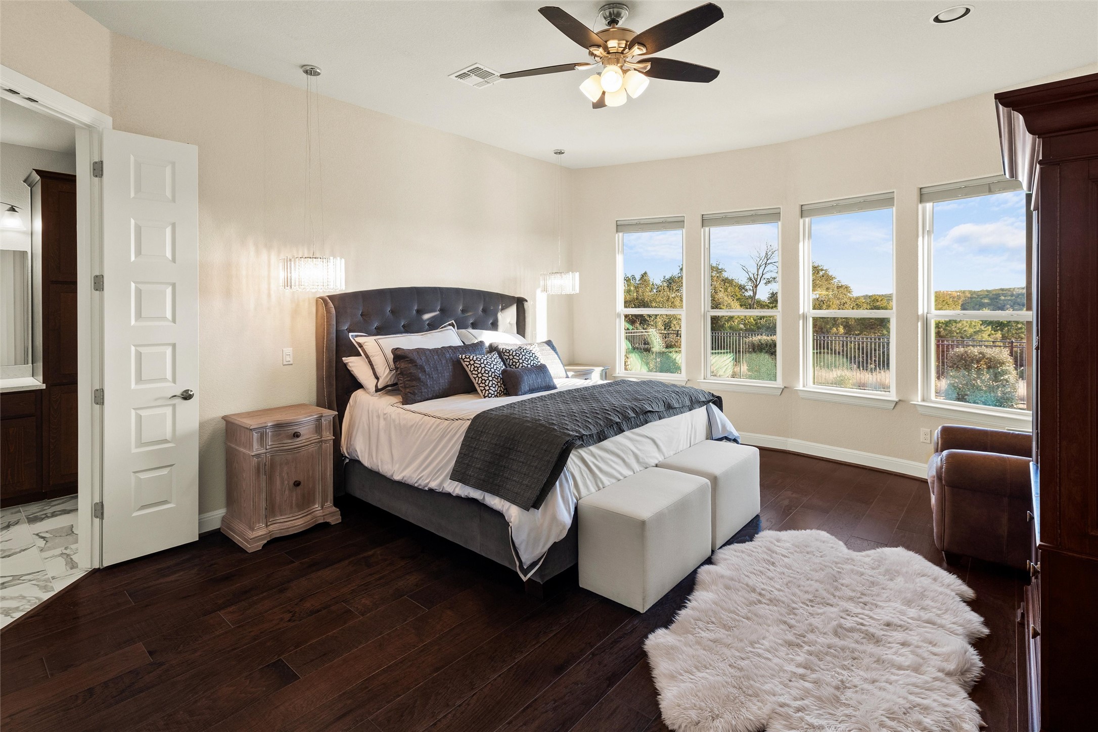 479 Crosswater Lane Dripping Springs, TX 78620 - Photo 18 of 40 a bedroom with a bed and wooden floor