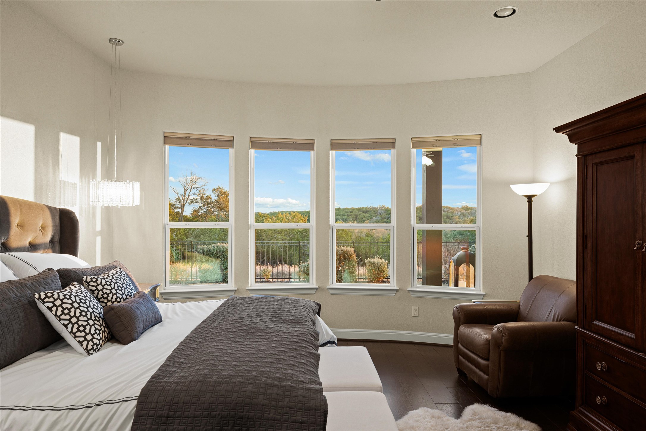 479 Crosswater Lane Dripping Springs, TX 78620 - Photo 19 of 40 a bedroom with a large bed and a large window