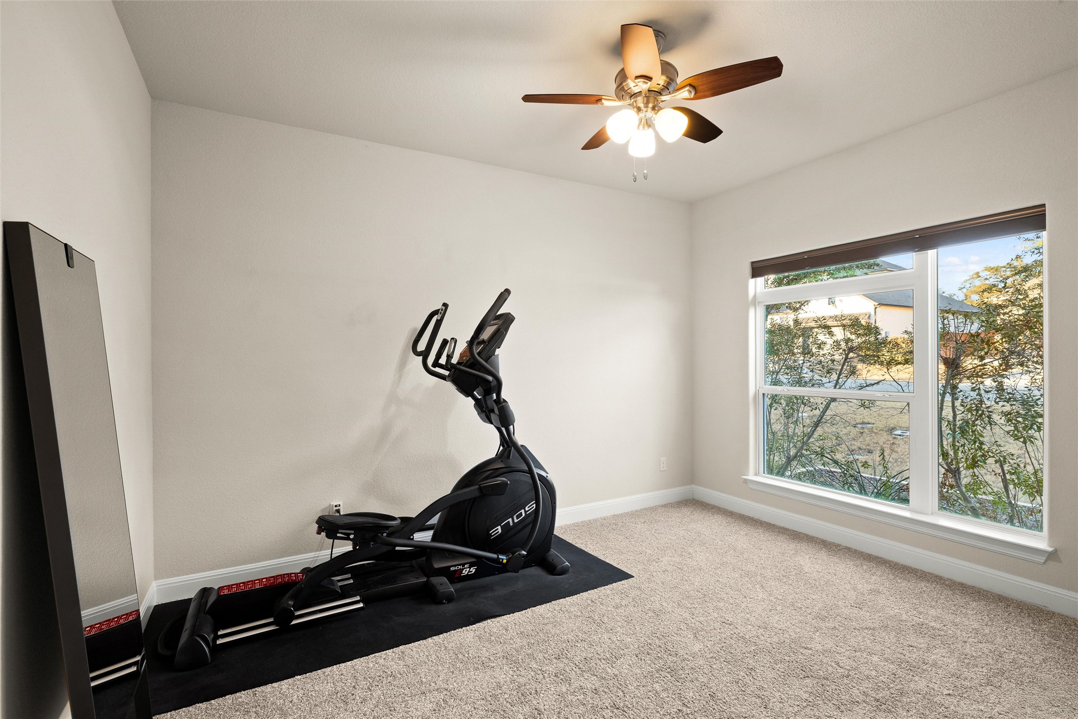 479 Crosswater Lane Dripping Springs, TX 78620 - Photo 26 of 40 a room with gym equipment and windows