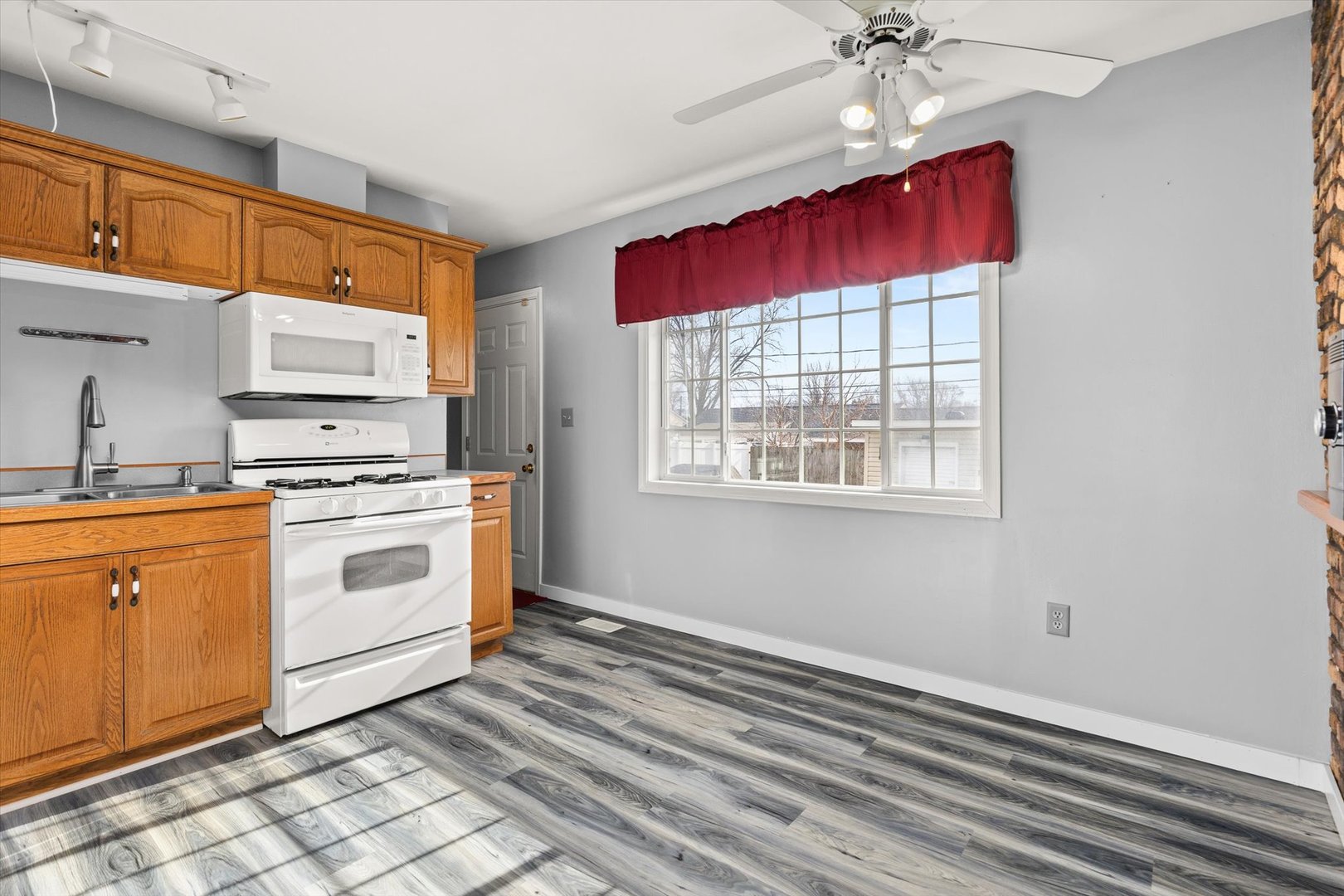 794 Farragut Avenue Romeoville, IL 60446 - Photo 14 of 23 a kitchen with stainless steel appliances granite countertop a stove a sink and a refrigerator