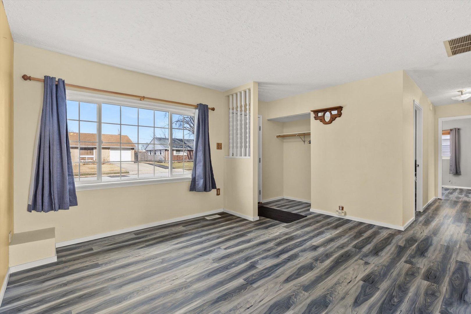 794 Farragut Avenue Romeoville, IL 60446 - Photo 4 of 23 a view of an empty room with wooden floor and a window