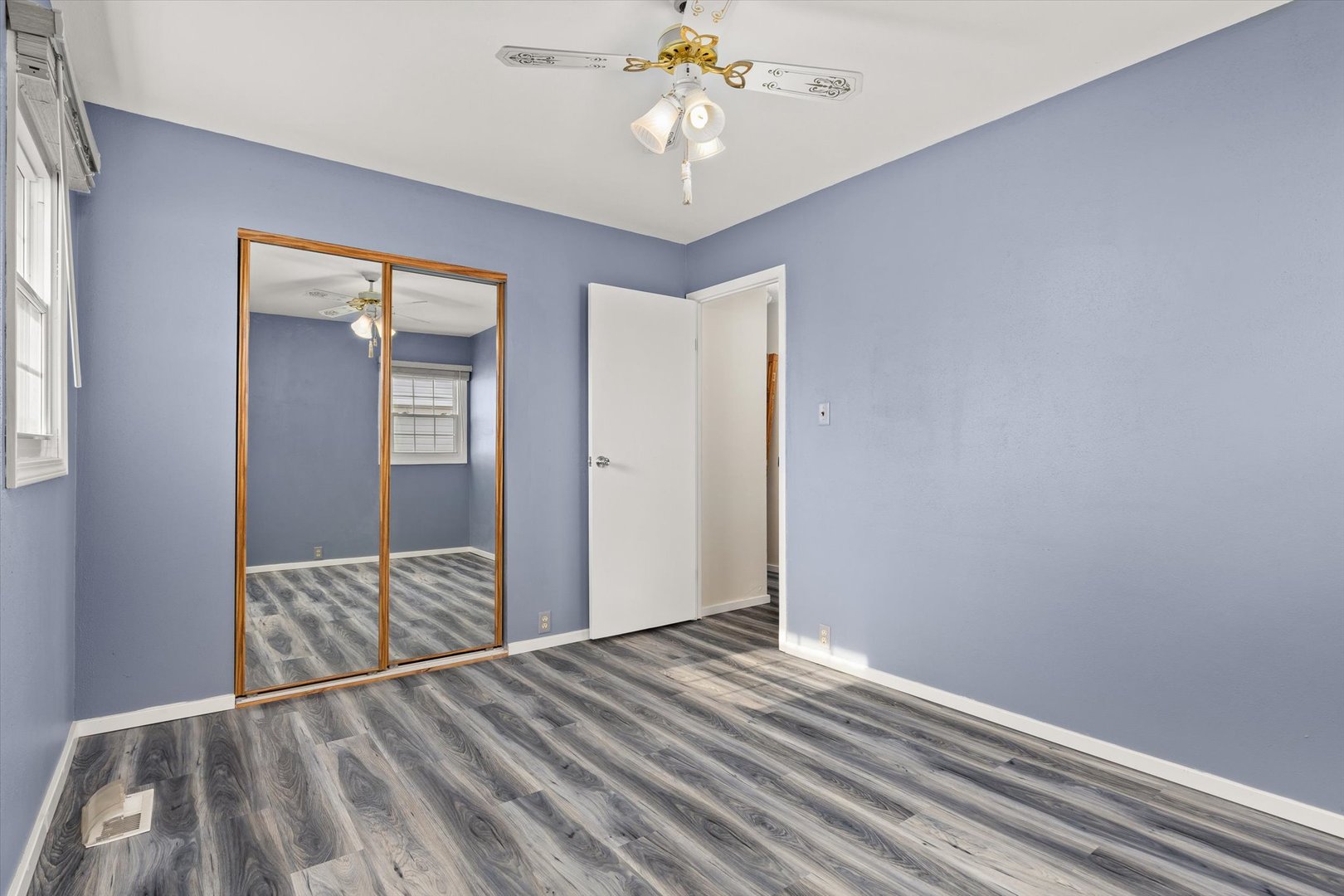 794 Farragut Avenue Romeoville, IL 60446 - Photo 6 of 23 a view of a livingroom with wooden floor and closet area