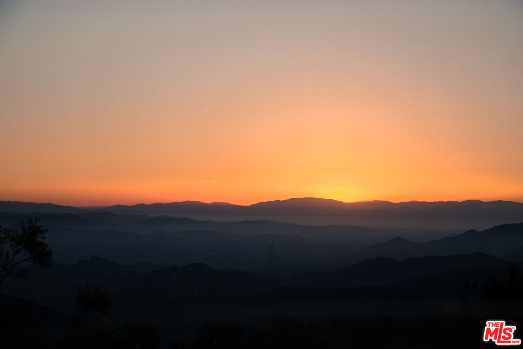 9950 Cotharin Road Malibu, CA 90265 - Photo 40 of 48 a view of a city with sunset view