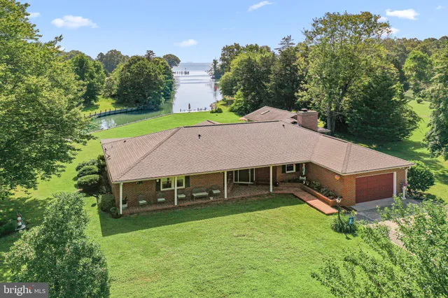 a aerial view of a house with a yard table and chairs