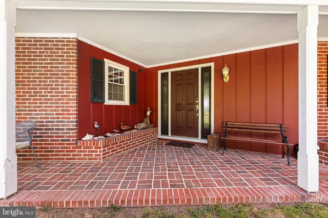 a view of a livingroom with dining area a rug and a window