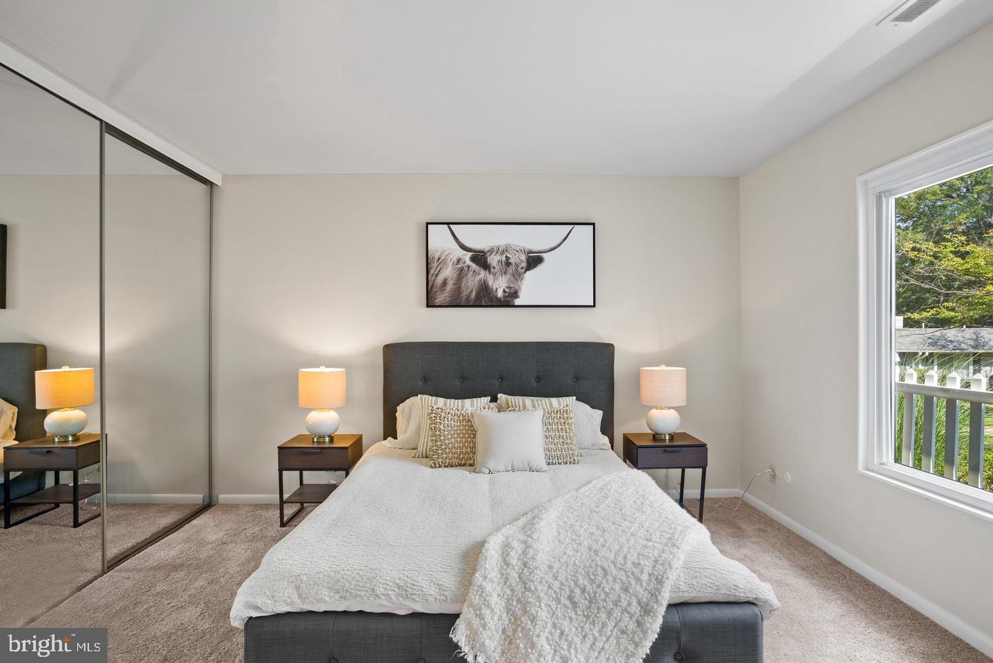 14654 Kelmscot Drive, Unit 236B Silver Spring, MD 20906 - Photo 14 of 27 a bedroom with a bed a mirror on table and a window