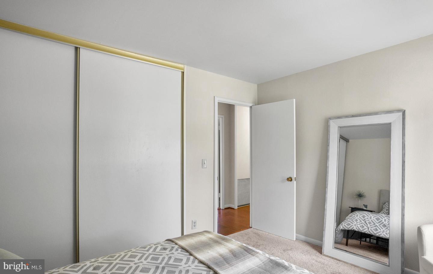 14654 Kelmscot Drive, Unit 236B Silver Spring, MD 20906 - Photo 19 of 27 a bedroom with a bed and a mirror
