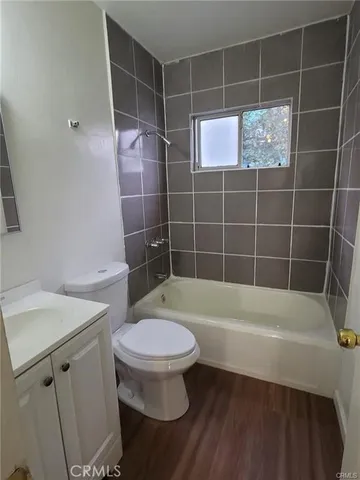 a bathroom with a toilet and a bathtub