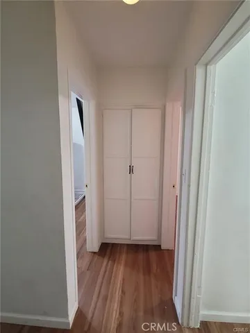 a view of a room with wooden floor