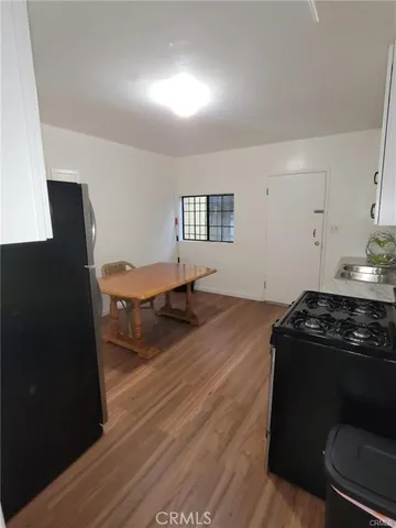 a kitchen with a stove and a refrigerator