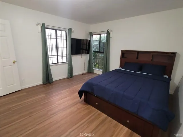 a bedroom with a bed and a view of kitchen