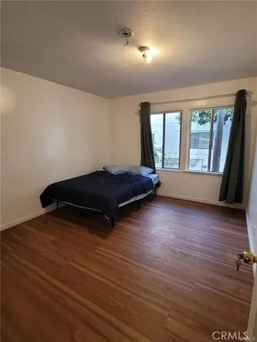 a living room with hard wood floors and a window