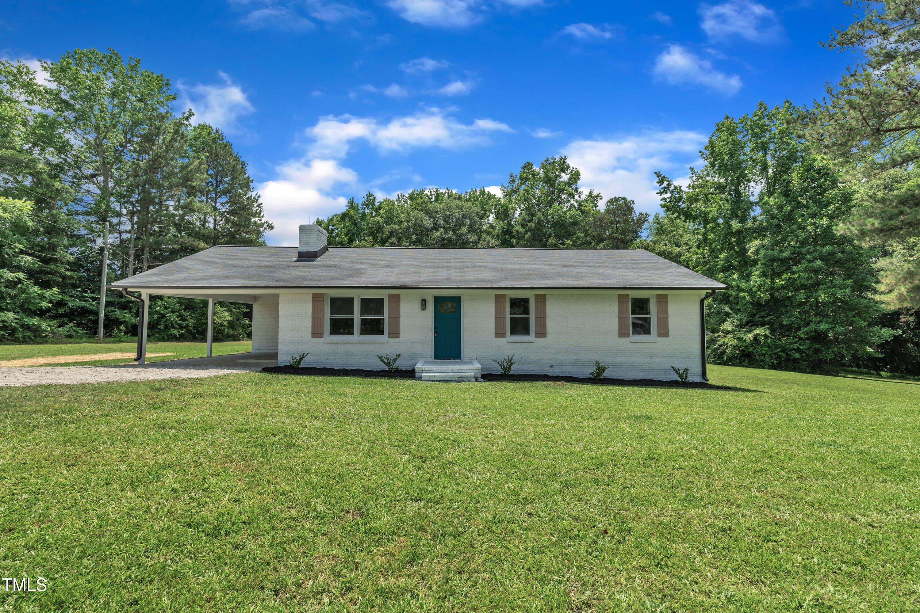 a front of a house with a garden