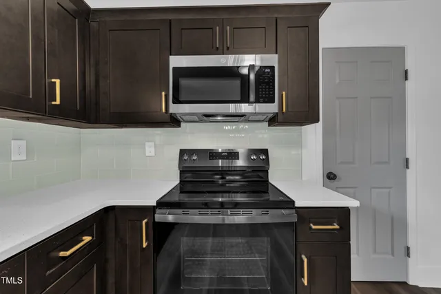 a kitchen with a stove and a microwave