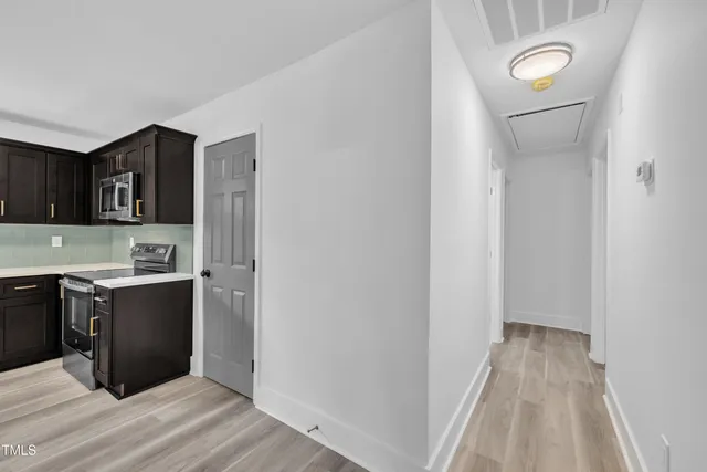 a view of a kitchen from the hallway