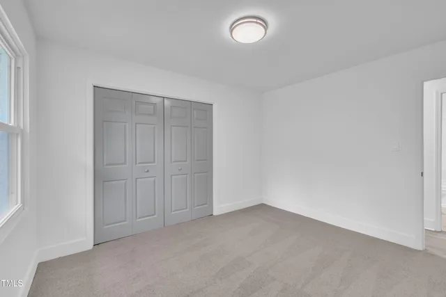 an empty room with closet area