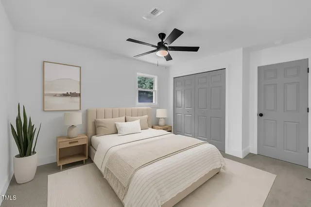 a bedroom with a bed and a potted plant