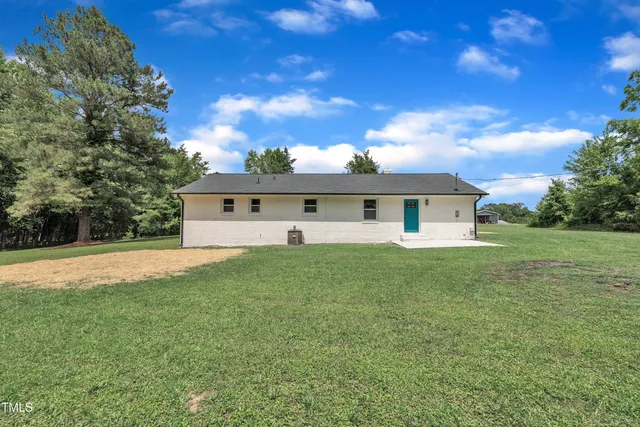 a front view of house with yard and trees