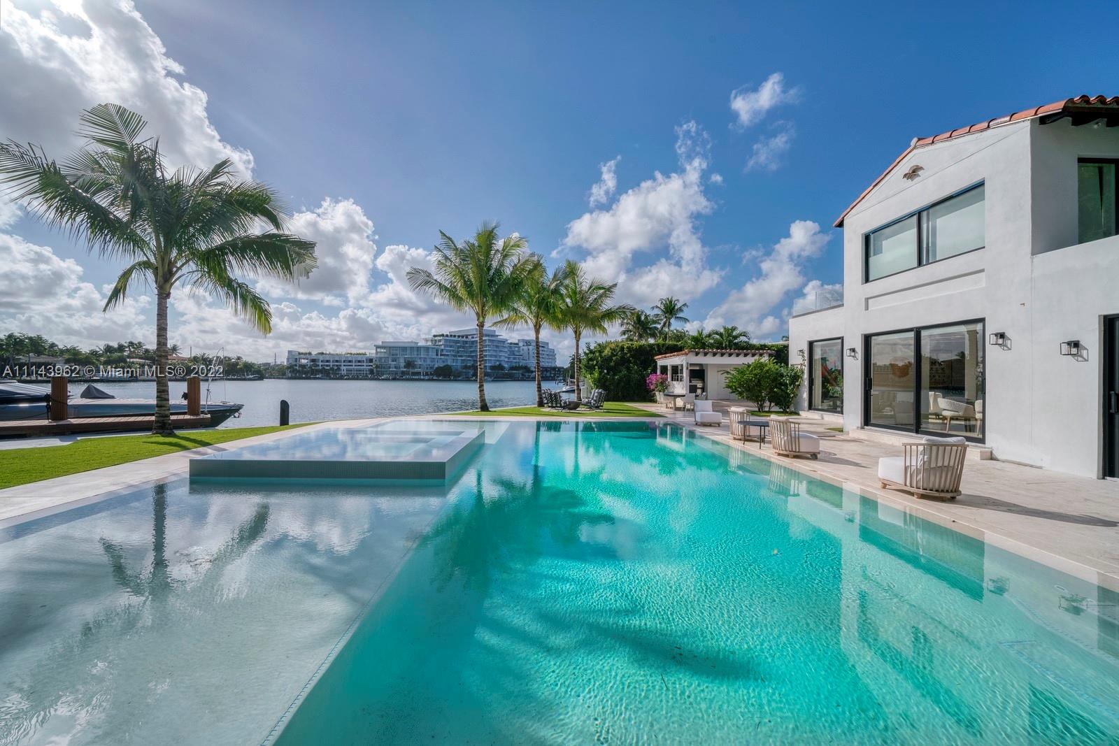 a view of a swimming pool with a garden and plants