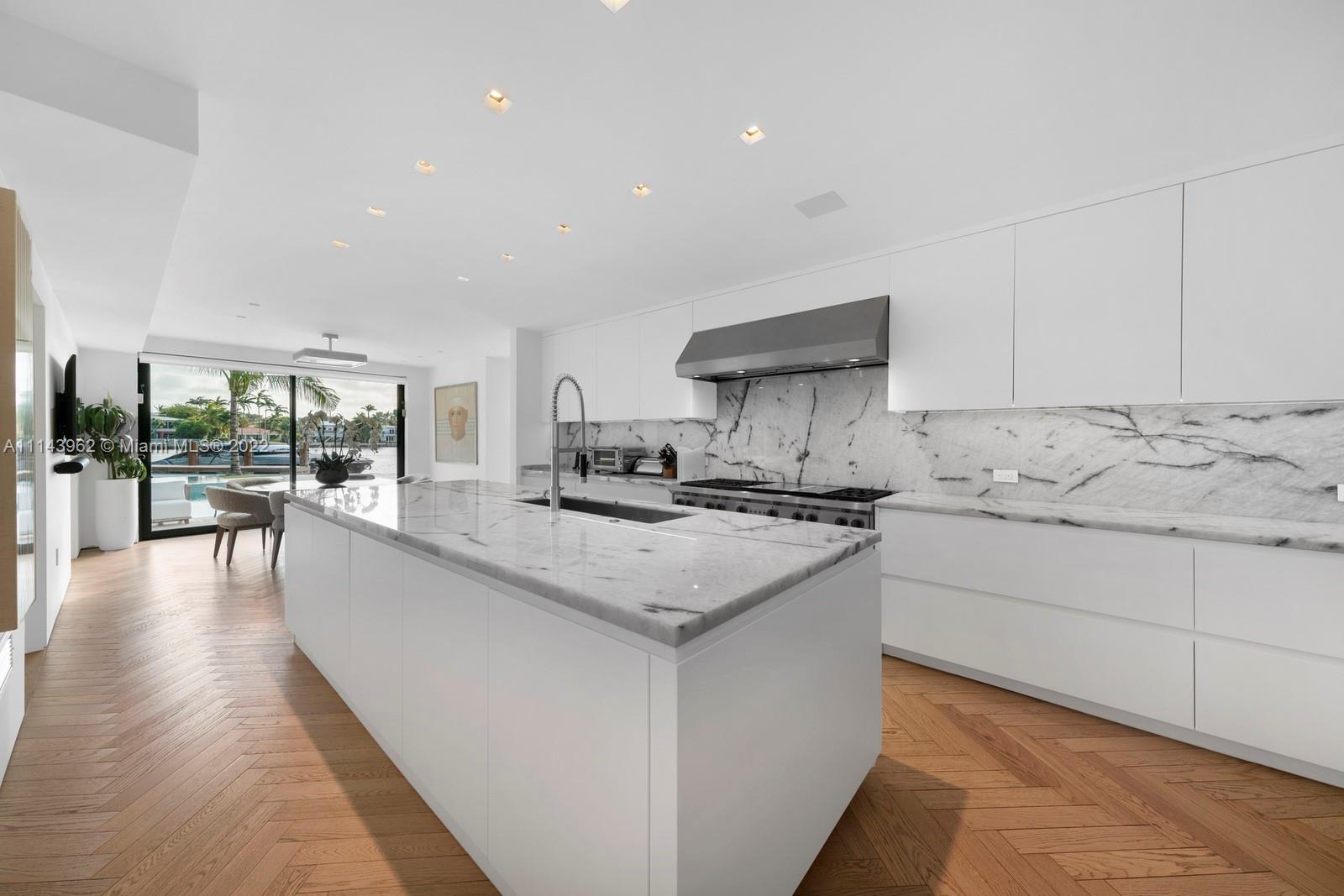 554 Lakeview Drive Miami Beach, FL 33140 - Photo 4 of 20 a kitchen with sink stove and cabinets