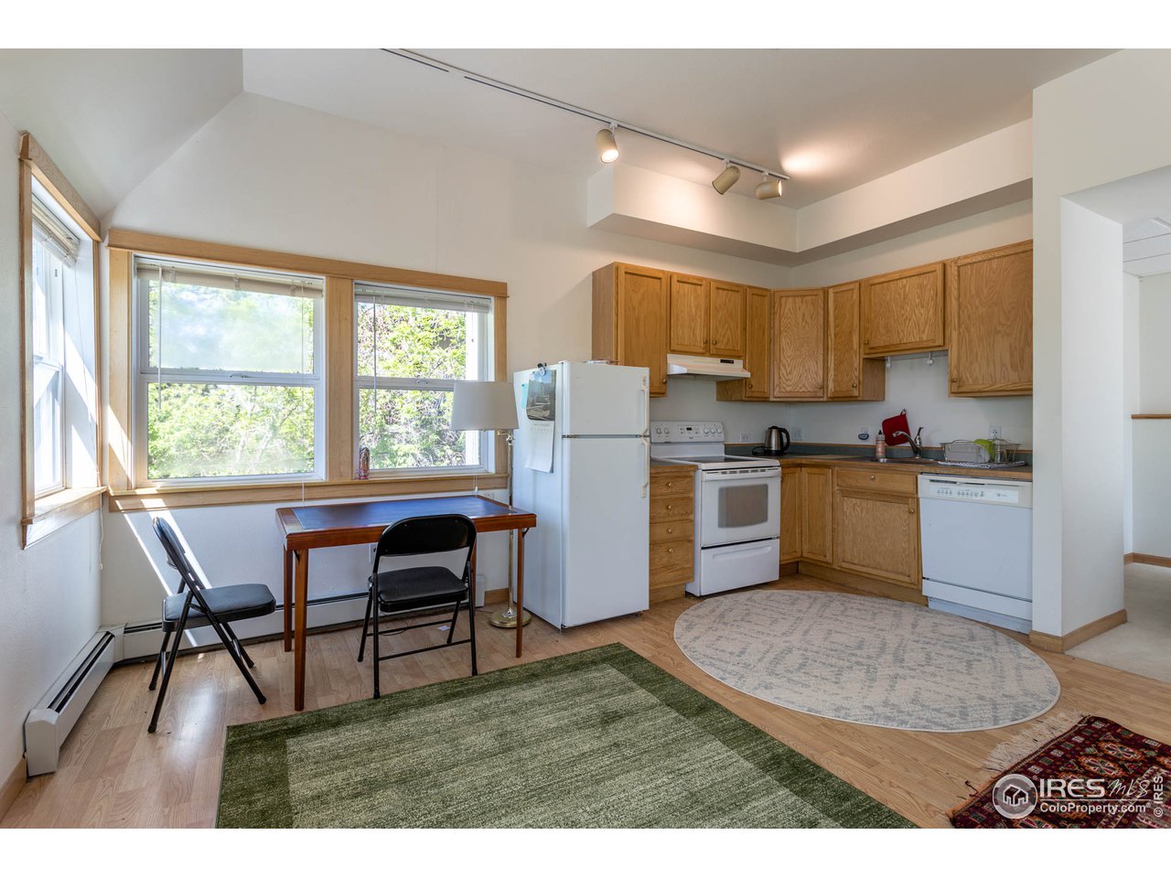 1450 High Street Boulder, CO 80304 - Photo 21 of 25 a kitchen with a dining table chairs and refrigerator