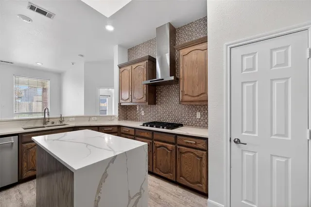 a kitchen that has a sink and a stove in it