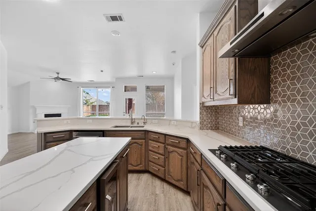 a kitchen with a sink stove and cabinets