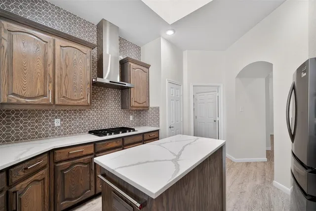 a kitchen with stainless steel appliances a sink a stove and a refrigerator