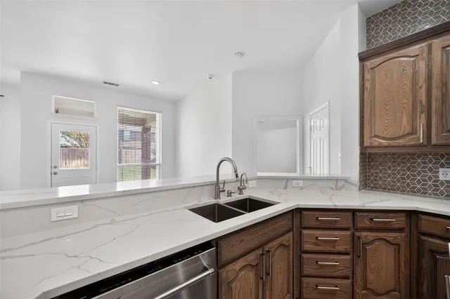 a kitchen with stainless steel appliances a sink stove and cabinets