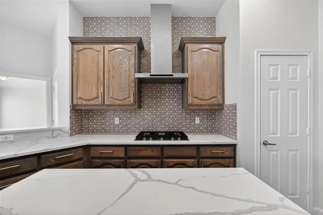 a kitchen with white cabinets and black appliances