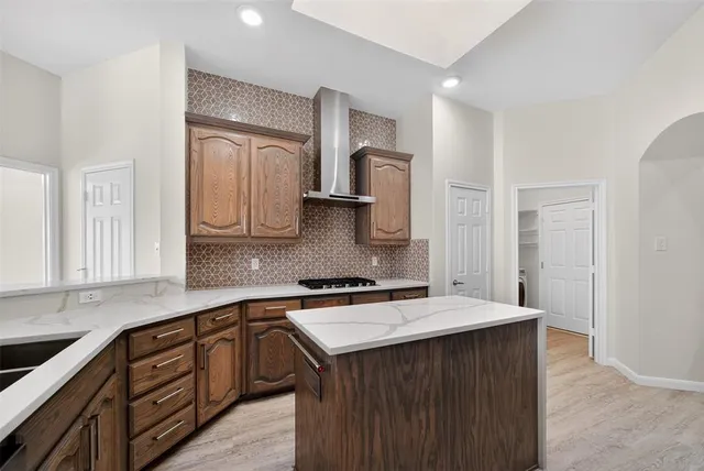 a kitchen with a sink stove and cabinets