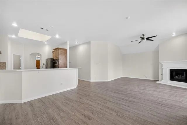 a view of a room with wooden floor and a fireplace