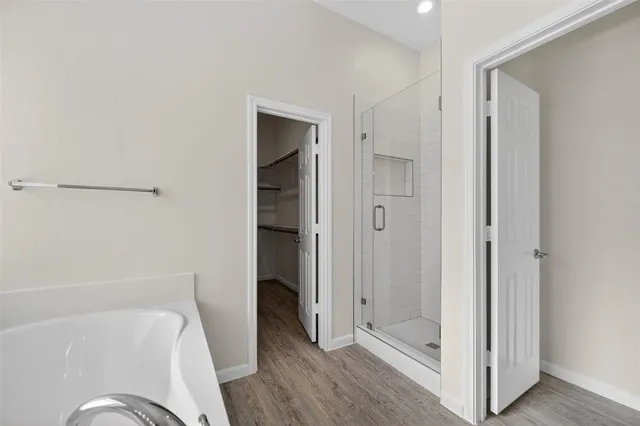 a bathroom with a tub and shower