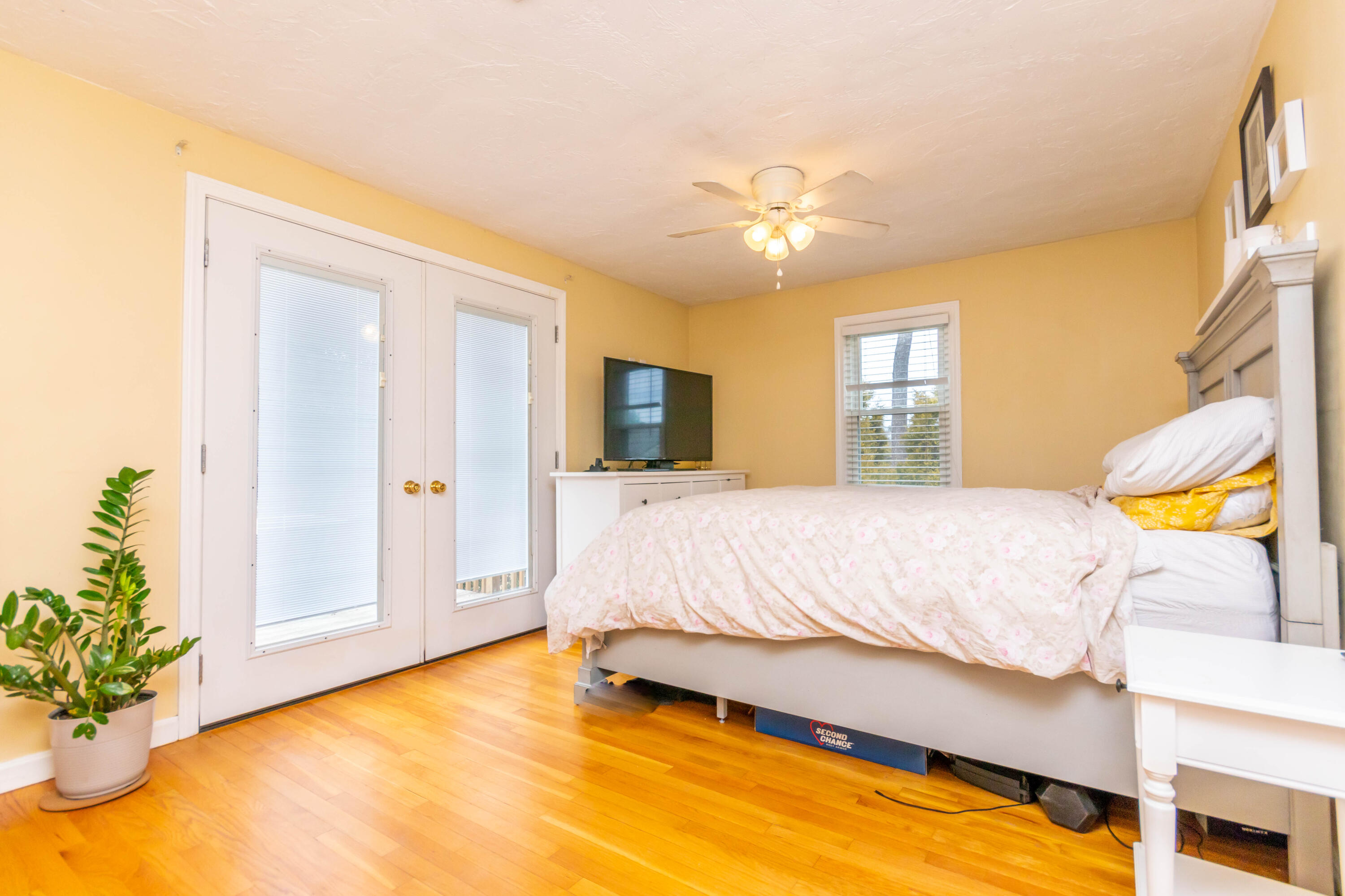 2 Long Boat Road Bourne, MA 02532 - Photo 12 of 30 a bedroom with a bed and a chandelier